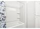 Clean white bathroom featuring a shower-tub combination with storage space for toiletries and linens at 9510 N Cooney Rd, Mooresville, IN 46158