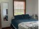 Cozy bedroom with a well-made bed, a mirror and natural light from the window at 9510 N Cooney Rd, Mooresville, IN 46158