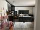 Bedroom with a large bed, neutral rug, side tables, and a variety of furniture and decor items at 9510 N Cooney Rd, Mooresville, IN 46158