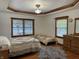 Comfortable bedroom with two beds, hardwood floors, and coordinated decor at 9510 N Cooney Rd, Mooresville, IN 46158
