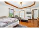 A well-lit bedroom featuring hardwood floors, a comfortable chair, and a view of the outdoors at 9510 N Cooney Rd, Mooresville, IN 46158