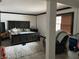 Bedroom with a large bed, neutral rug, side tables, and natural light, with a recliner in the distance at 9510 N Cooney Rd, Mooresville, IN 46158