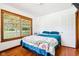 Cozy bedroom features a large window and hardwood floors at 9510 N Cooney Rd, Mooresville, IN 46158