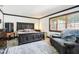Bedroom featuring a queen bed, window with blinds, and a comfortable seating area, creating a cozy retreat at 9510 N Cooney Rd, Mooresville, IN 46158