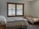 Bedroom with two beds, hardwood floors, neutral decor, and natural light at 9510 N Cooney Rd, Mooresville, IN 46158