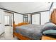 Bedroom featuring a wooden bed frame and access to multiple rooms, offering a serene and accessible space at 9510 N Cooney Rd, Mooresville, IN 46158