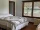 Bedroom showcasing bed, wood floors, and a window for natural light at 9510 N Cooney Rd, Mooresville, IN 46158