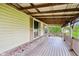 Enjoy the outdoors on this expansive covered porch with brick accents, offering views of the tranquil landscape at 9510 N Cooney Rd, Mooresville, IN 46158