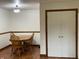Cozy dining room with wood trim and laminate floor, adjacent to white closet at 9510 N Cooney Rd, Mooresville, IN 46158