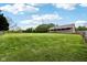 A sprawling green lawn complements this cozy home featuring a covered front porch and surrounding wooded landscape at 9510 N Cooney Rd, Mooresville, IN 46158