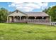 Charming single-story home featuring a full-length covered front porch and a spacious lawn at 9510 N Cooney Rd, Mooresville, IN 46158