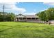Single-story home with a covered front porch overlooking a large grassy yard with mature trees at 9510 N Cooney Rd, Mooresville, IN 46158