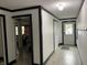 Hallway with a view of bedroom and multiple doorways, white walls with black trim and modern lighting at 9510 N Cooney Rd, Mooresville, IN 46158