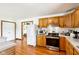 Kitchen with white refrigerator, wooden cabinetry, and stainless steel oven at 9510 N Cooney Rd, Mooresville, IN 46158