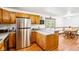An eat-in kitchen with wood cabinets, stainless steel appliances, and a dining area with a view at 9510 N Cooney Rd, Mooresville, IN 46158