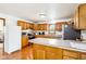 Kitchen showcasing wood cabinets, stainless appliances, and a breakfast bar peninsula at 9510 N Cooney Rd, Mooresville, IN 46158