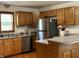Bright kitchen featuring stainless steel refrigerator, light wood cabinetry, and laminate countertops at 9510 N Cooney Rd, Mooresville, IN 46158