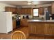 Spacious kitchen with oak cabinets, stainless steel appliances, and functional island at 9510 N Cooney Rd, Mooresville, IN 46158