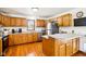 Kitchen featuring wood cabinets, stainless steel appliances, and a breakfast bar at 9510 N Cooney Rd, Mooresville, IN 46158