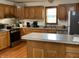 Traditional kitchen with stainless steel appliances, wood cabinets, and functional island at 9510 N Cooney Rd, Mooresville, IN 46158