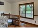 Loft area with wood railing, hardwood floors and large window, offering a bright space at 9510 N Cooney Rd, Mooresville, IN 46158