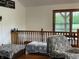Cozy loft area with wood railing and large windows offering views of the outdoors at 9510 N Cooney Rd, Mooresville, IN 46158