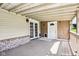 This covered porch has light tan siding with red brick, gray wood flooring and a light ceiling at 9510 N Cooney Rd, Mooresville, IN 46158