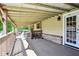 This porch features a light tan siding with wood columns and a gray wood flooring at 9510 N Cooney Rd, Mooresville, IN 46158