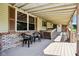 This porch has red brick at the base, a small table and light tan siding with white trim at 9510 N Cooney Rd, Mooresville, IN 46158