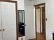 A room with multiple doorways and a vanity with a mirror at 9510 N Cooney Rd, Mooresville, IN 46158