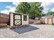 This property has 2 sheds with gravel in front, light siding and dark trim at 9510 N Cooney Rd, Mooresville, IN 46158
