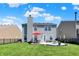 Beautiful backyard featuring a patio set with a red umbrella, black fencing, and well-maintained lawn at 9557 W Lantern Ln, Pendleton, IN 46064