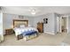 Spacious bedroom featuring neutral walls, carpet, a ceiling fan, and a decorative upholstered headboard at 9557 W Lantern Ln, Pendleton, IN 46064