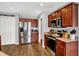 Well-lit kitchen featuring stainless steel appliances, wood-look floors, and plentiful cabinet space at 9557 W Lantern Ln, Pendleton, IN 46064
