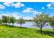 Lake view featuring well manicured trees and lawn at 9557 W Lantern Ln, Pendleton, IN 46064