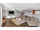 Inviting living room with plush seating, a mounted TV, and stylish decor elements at 9557 W Lantern Ln, Pendleton, IN 46064