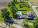Aerial view of a spacious home featuring a large in-ground pool, lush green lawn, and mature trees in a rural setting at 9579 N Fortville Pike, Fortville, IN 46040