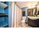 Modern bathroom with blue walls, storage shelves, and tiled floors at 9579 N Fortville Pike, Fortville, IN 46040