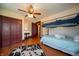 Cozy bedroom featuring a bunk bed, hardwood floors, and ceiling fan at 9579 N Fortville Pike, Fortville, IN 46040