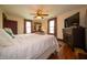 Bedroom with hardwood flooring and neutral paint, natural light from two windows, and a ceiling fan at 9579 N Fortville Pike, Fortville, IN 46040