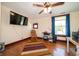 Bright bedroom showcasing hardwood floors, ceiling fan, and natural light at 9579 N Fortville Pike, Fortville, IN 46040