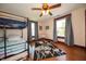 Bedroom with hardwood floors and a bunk bed, as well as natural light from two windows at 9579 N Fortville Pike, Fortville, IN 46040
