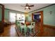 Dining room with decorative rug, wooden table, hardwood floors, and view into the living room at 9579 N Fortville Pike, Fortville, IN 46040