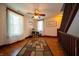 Hallway with hardwood flooring, two windows, and staircase to the second story at 9579 N Fortville Pike, Fortville, IN 46040