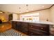 Spacious kitchen features a center island with dark cabinetry, stone counters, and pendant lights at 9579 N Fortville Pike, Fortville, IN 46040