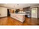 Bright kitchen with a large brick island, stainless steel appliances, and hardwood floors at 9579 N Fortville Pike, Fortville, IN 46040