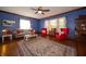 Cozy living room features a ceiling fan, hardwood floors, large rug, and comfortable seating at 9579 N Fortville Pike, Fortville, IN 46040