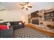 Living room featuring a brick fireplace, ceiling fan, and modern decor at 9579 N Fortville Pike, Fortville, IN 46040