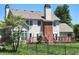 Back of the house featuring a large deck perfect for outdoor entertaining and lush landscaping at 9909 E Mcgregor Rd, Indianapolis, IN 46259