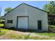 Large barn with a garage door and side door perfect for storage or workshop at 9909 E Mcgregor Rd, Indianapolis, IN 46259